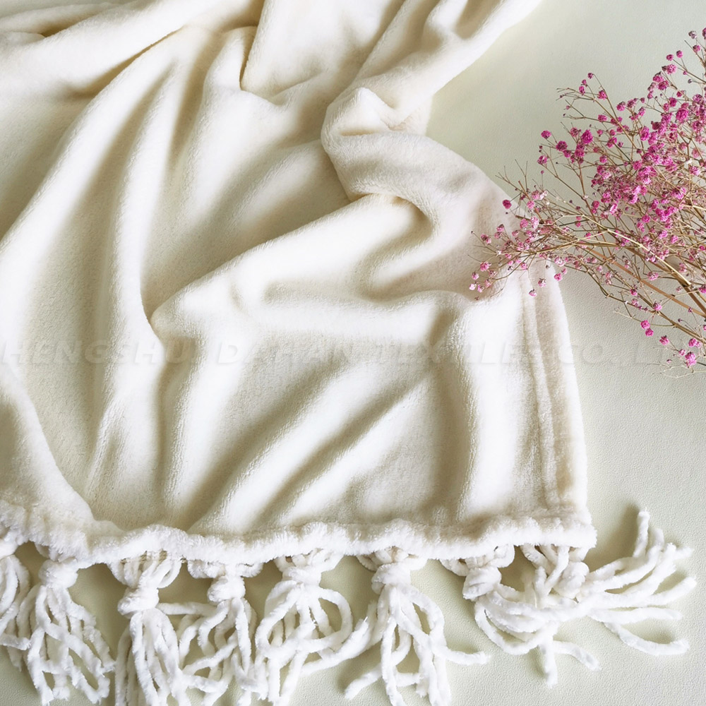 8028 Solid color coral fleece blanket with tassels.